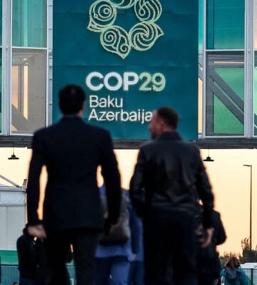 Men walking into the COP29 conference in Baku, Azerbaijan