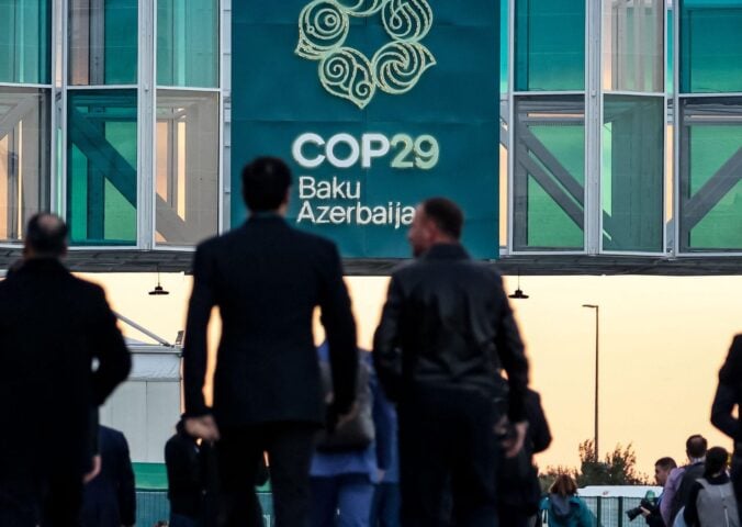 Men walking into the COP29 conference in Baku, Azerbaijan