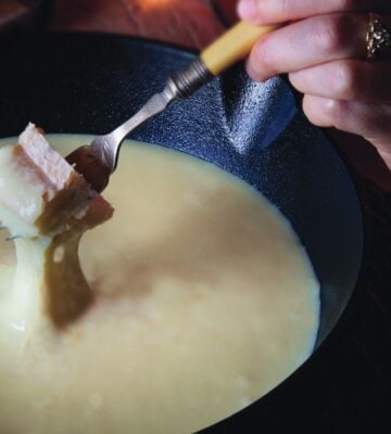 bread dipped in a creamy alpine fondue that is vegan