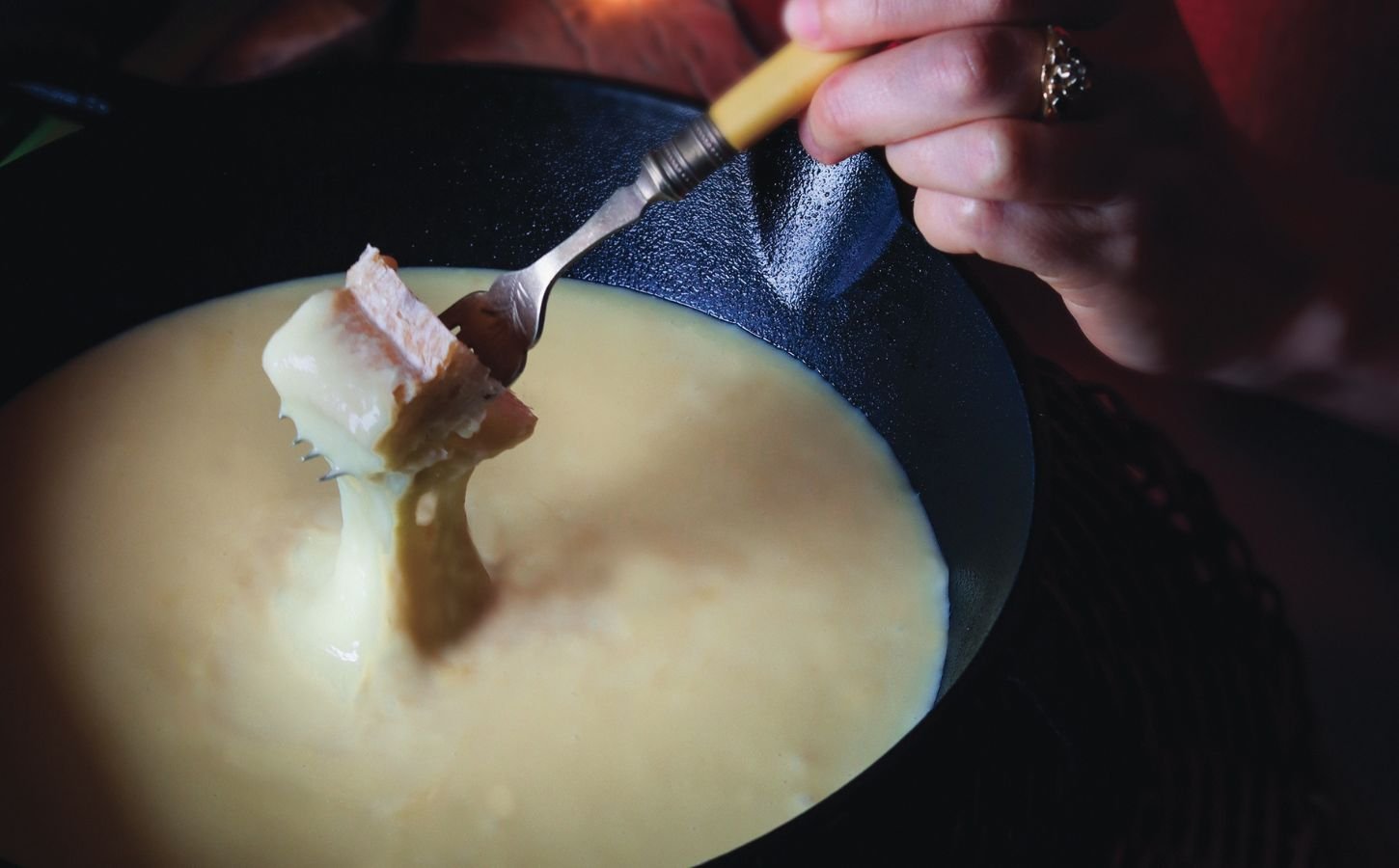 bread dipped in a creamy alpine fondue that is vegan