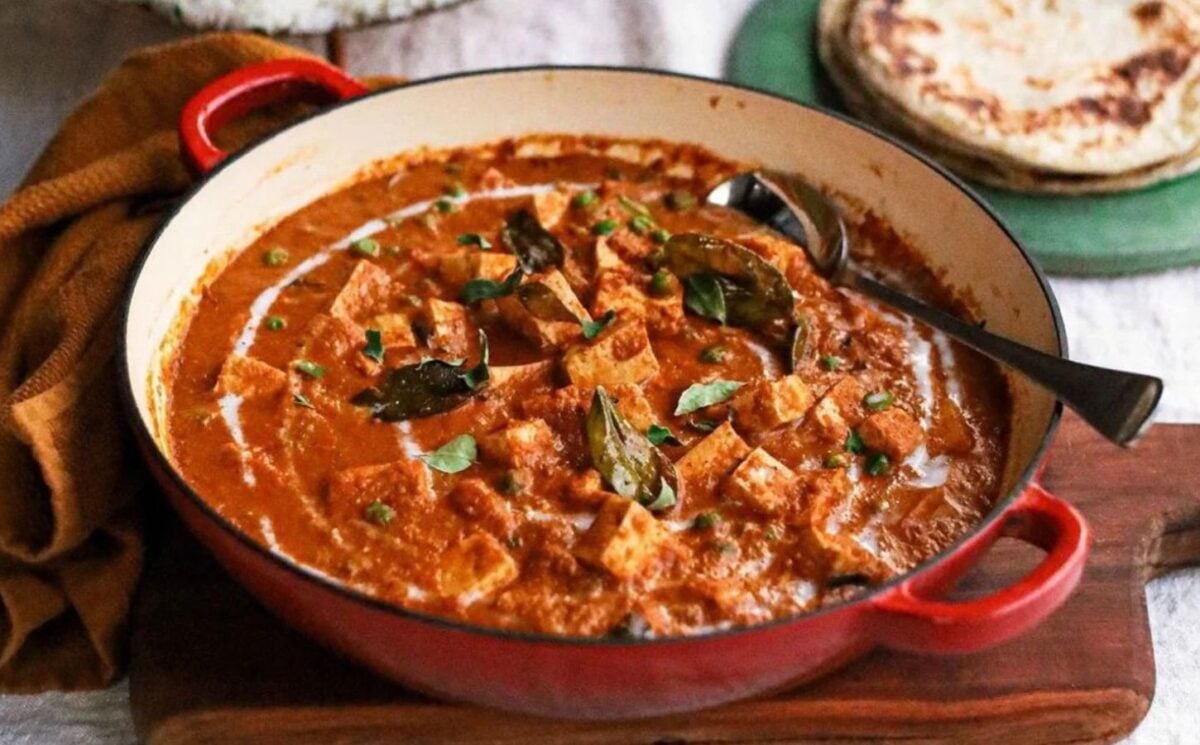 a pot of butter tofu curry with naan and basmati rice