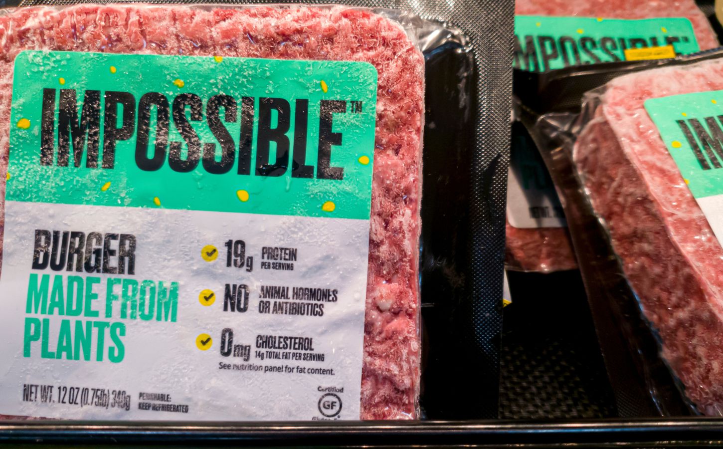 Some Impossible Foods burgers on a supermarket shelf