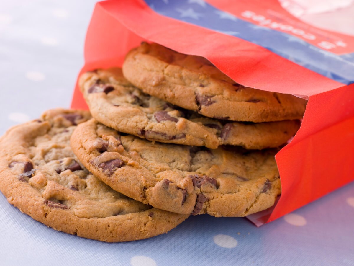 Photo shows a red paper bag of chocolate chip cookies