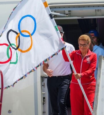 Los Angeles Mayor Karen Bass holds the official Olympic flag at Los Angeles International Airport