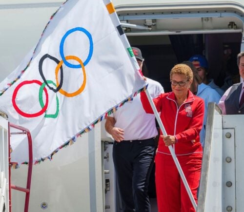 Los Angeles Mayor Karen Bass holds the official Olympic flag at Los Angeles International Airport