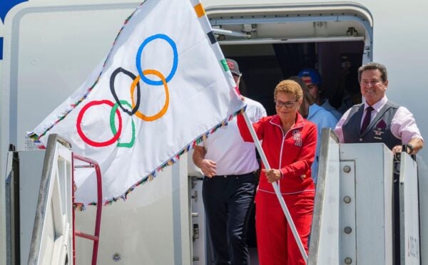 Los Angeles Mayor Karen Bass holds the official Olympic flag at Los Angeles International Airport