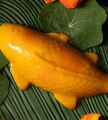 a picture of a vegan mango pudding shaped like a koi fish