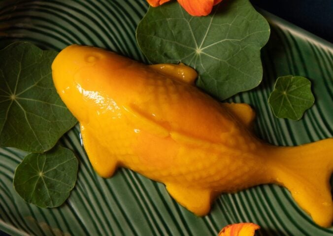 a picture of a vegan mango pudding shaped like a koi fish