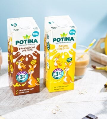 Photo shows both flavors of the new Potina drink on a table with a glass and several bananas