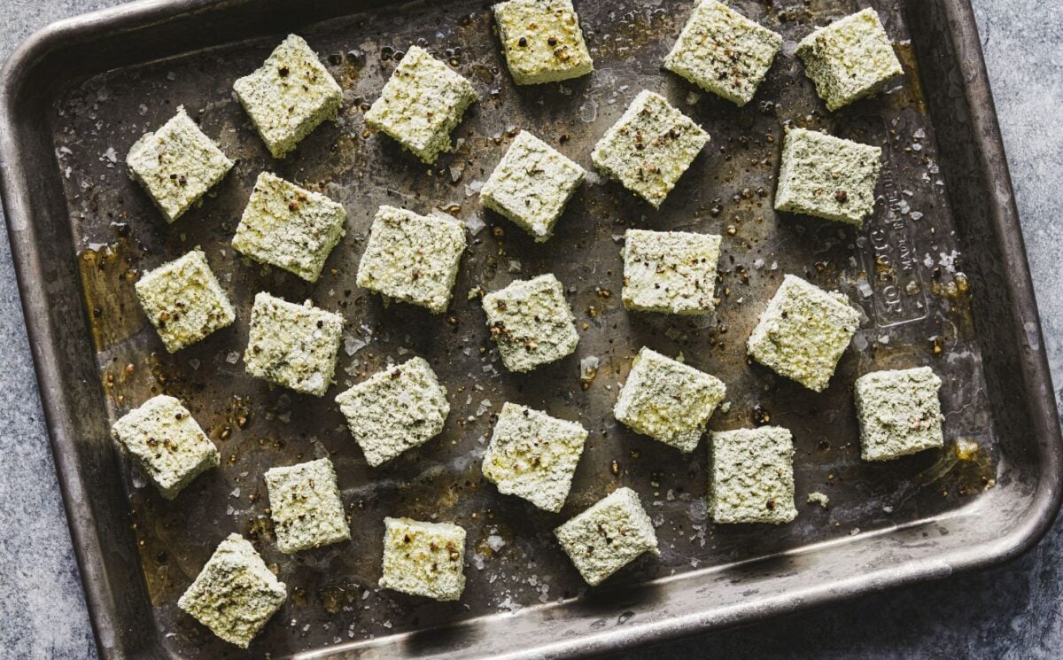 a tray of seasoned pumpkin seed tofu cubes