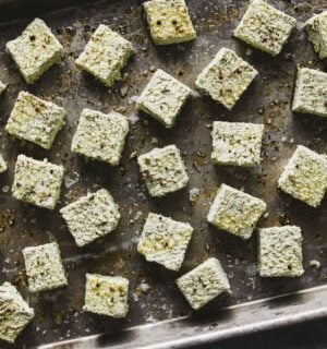 a tray of seasoned pumpkin seed tofu cubes