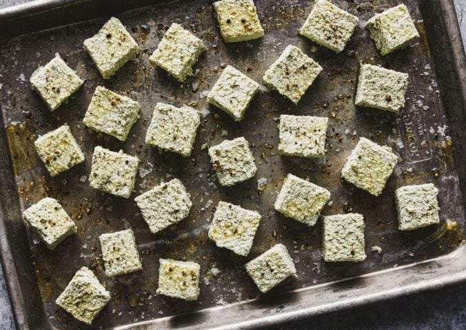 a tray of seasoned pumpkin seed tofu cubes