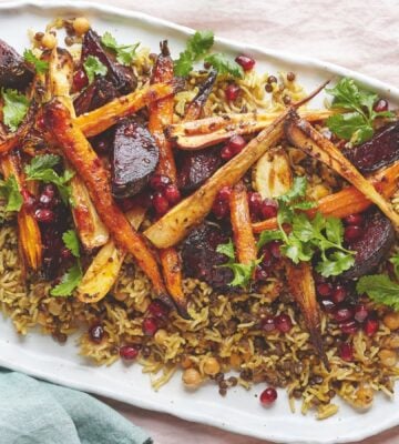 a platter of rice and lentils with tahini roasted root veg served with a zesty dressing