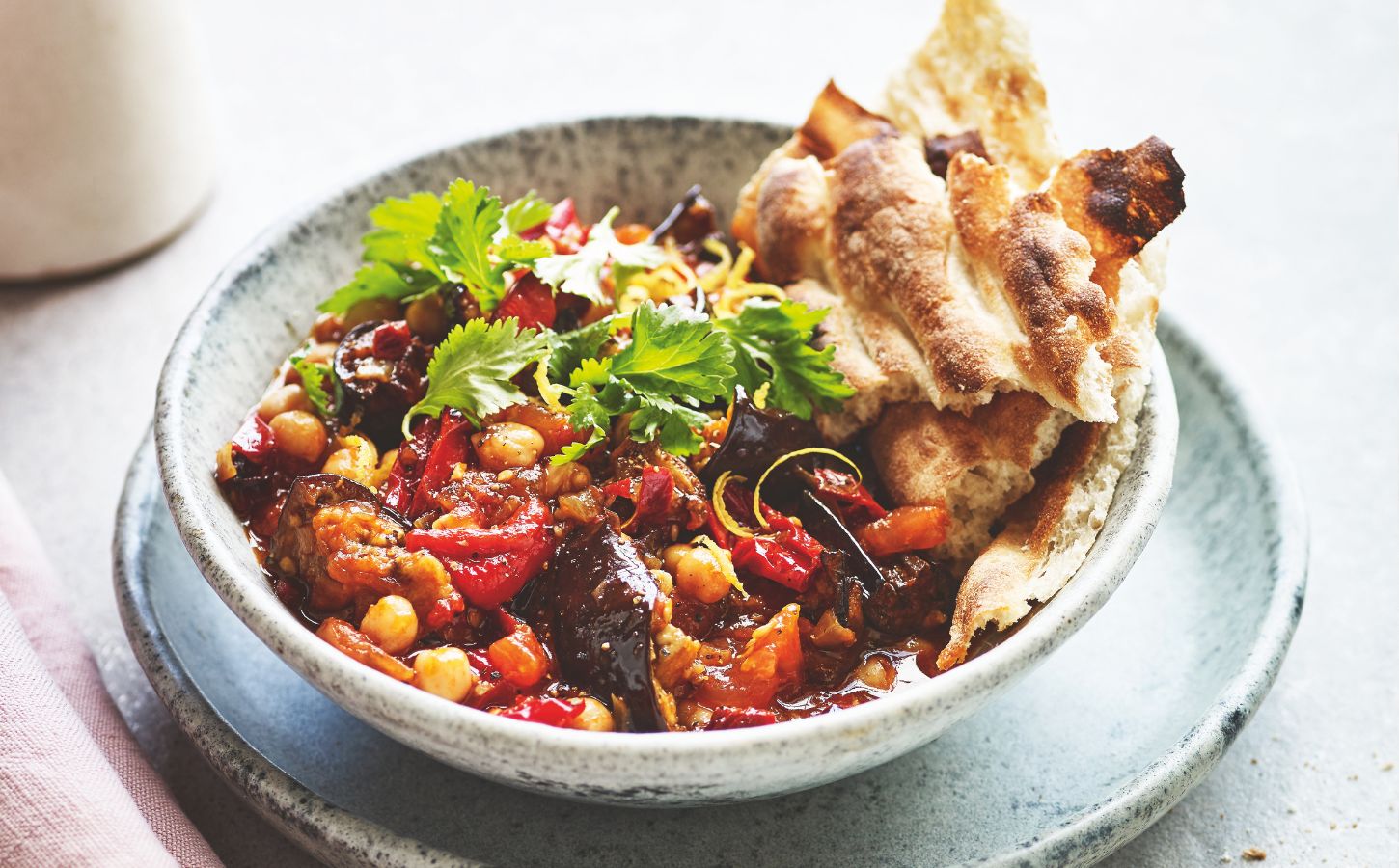 a bowl of smoky aubergine with tomato and chickpeas made with chipotle chilies