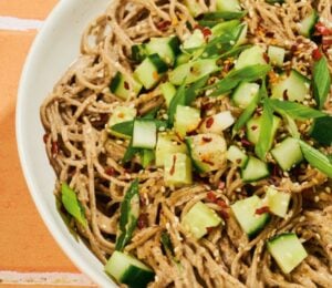 a bowl of soba noodles with cucumber and a miso pecan butter