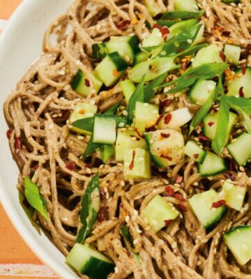 a bowl of soba noodles with cucumber and a miso pecan butter