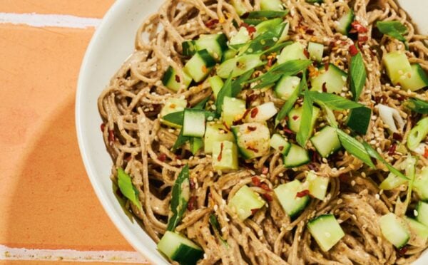 a bowl of soba noodles with cucumber and a miso pecan butter