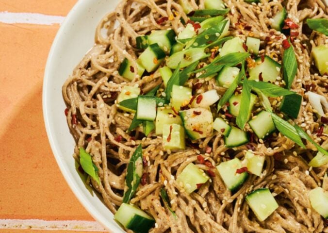 a bowl of soba noodles with cucumber and a miso pecan butter