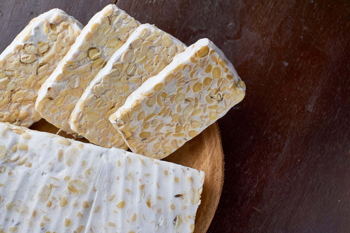 Blocks of tempeh on a wooden block