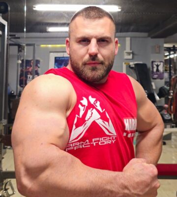 A vegan arm wrestling champion flexing his muscles