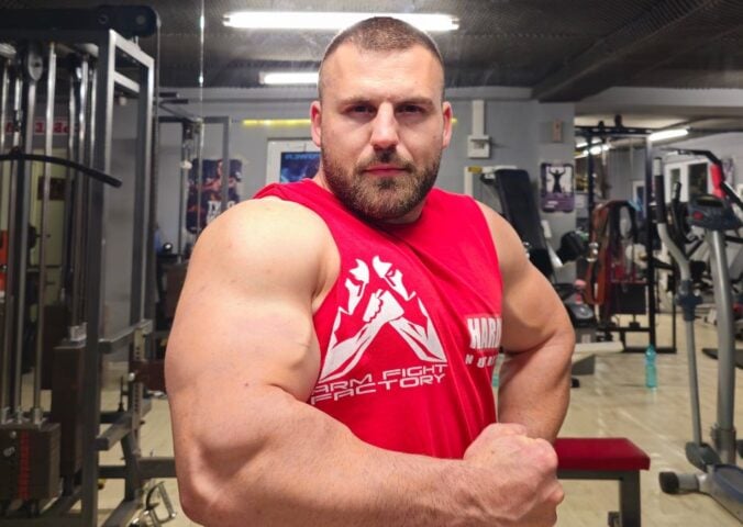 A vegan arm wrestling champion flexing his muscles