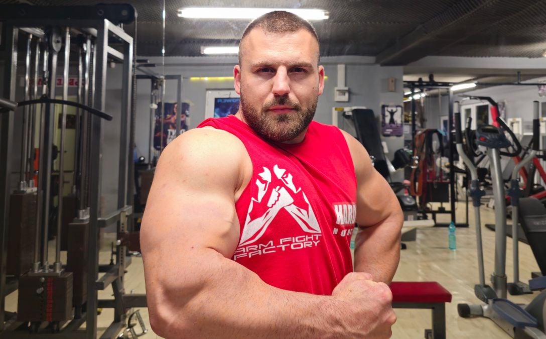 A vegan arm wrestling champion flexing his muscles