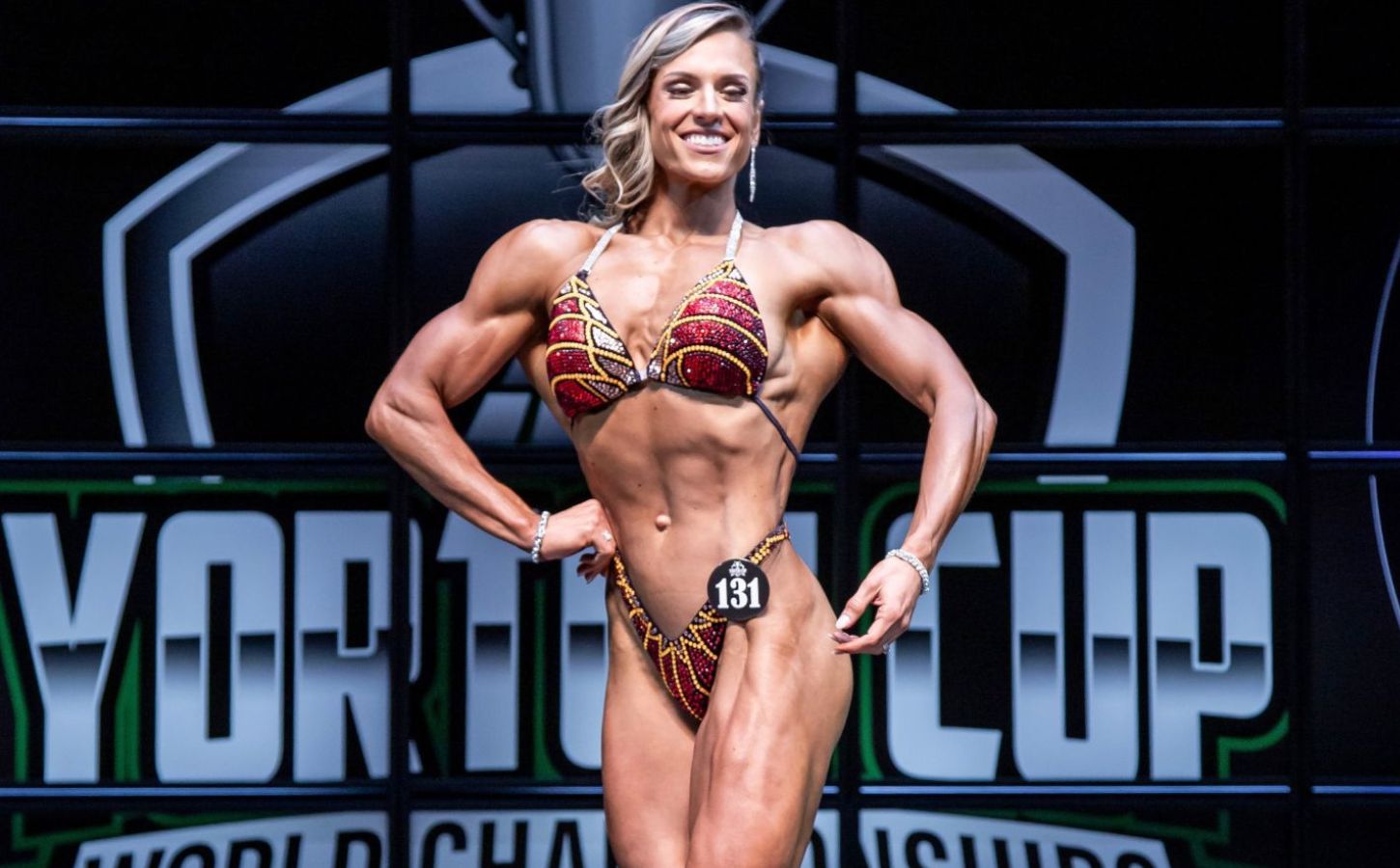 Vegan bodybuilder Maddie McConnell competing stage in a bikini