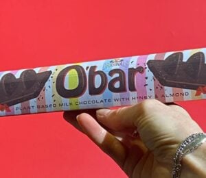 A hand holding up a Toblerone-style vegan bar named O'Bar from Catherine's Originals