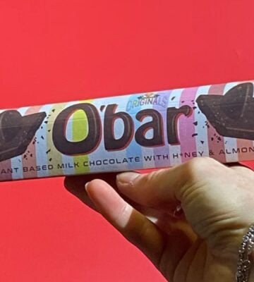 A hand holding up a Toblerone-style vegan bar named O'Bar from Catherine's Originals