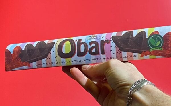 A hand holding up a Toblerone-style vegan bar named O'Bar from Catherine's Originals