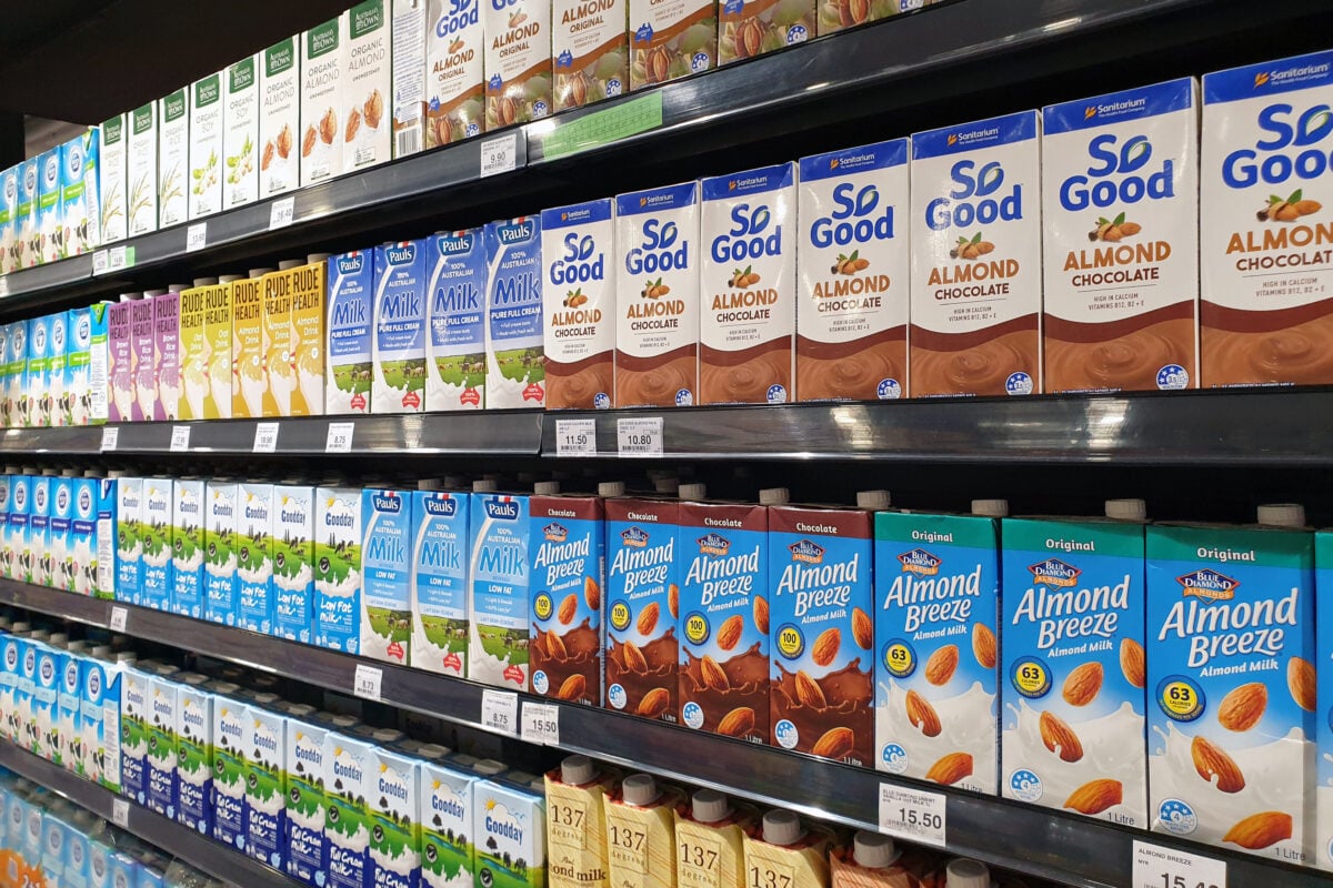 Photo shows a selection of UHT plant milk on a supermarket shelf