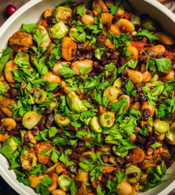 a bowl of chopped, caramelized sprouts with butter beans and chestnuts