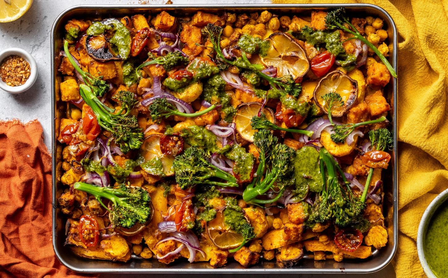 a vegan zesty chickpea traybake with cherry tomato confit