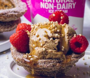 vegan churro ice cream cups filled with dairy-free ice cream and raspberries