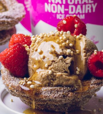 vegan churro ice cream cups filled with dairy-free ice cream and raspberries