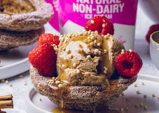 vegan churro ice cream cups filled with dairy-free ice cream and raspberries