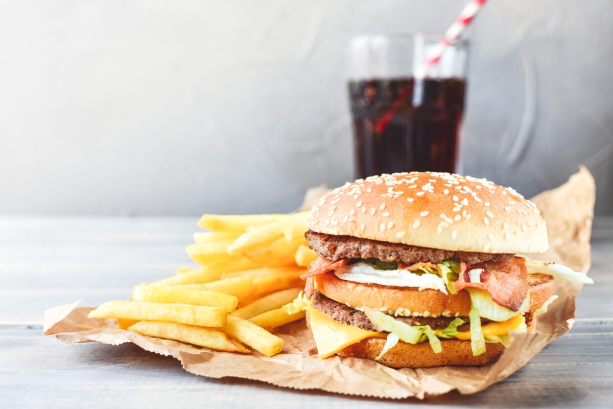 A burger and chips with a drink