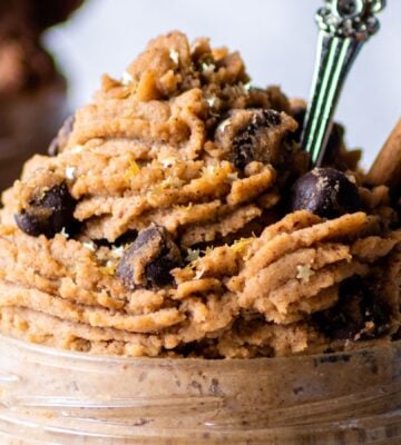 a jar of piped vegan gingerbread cookie dough made with chickpeas and almond butter