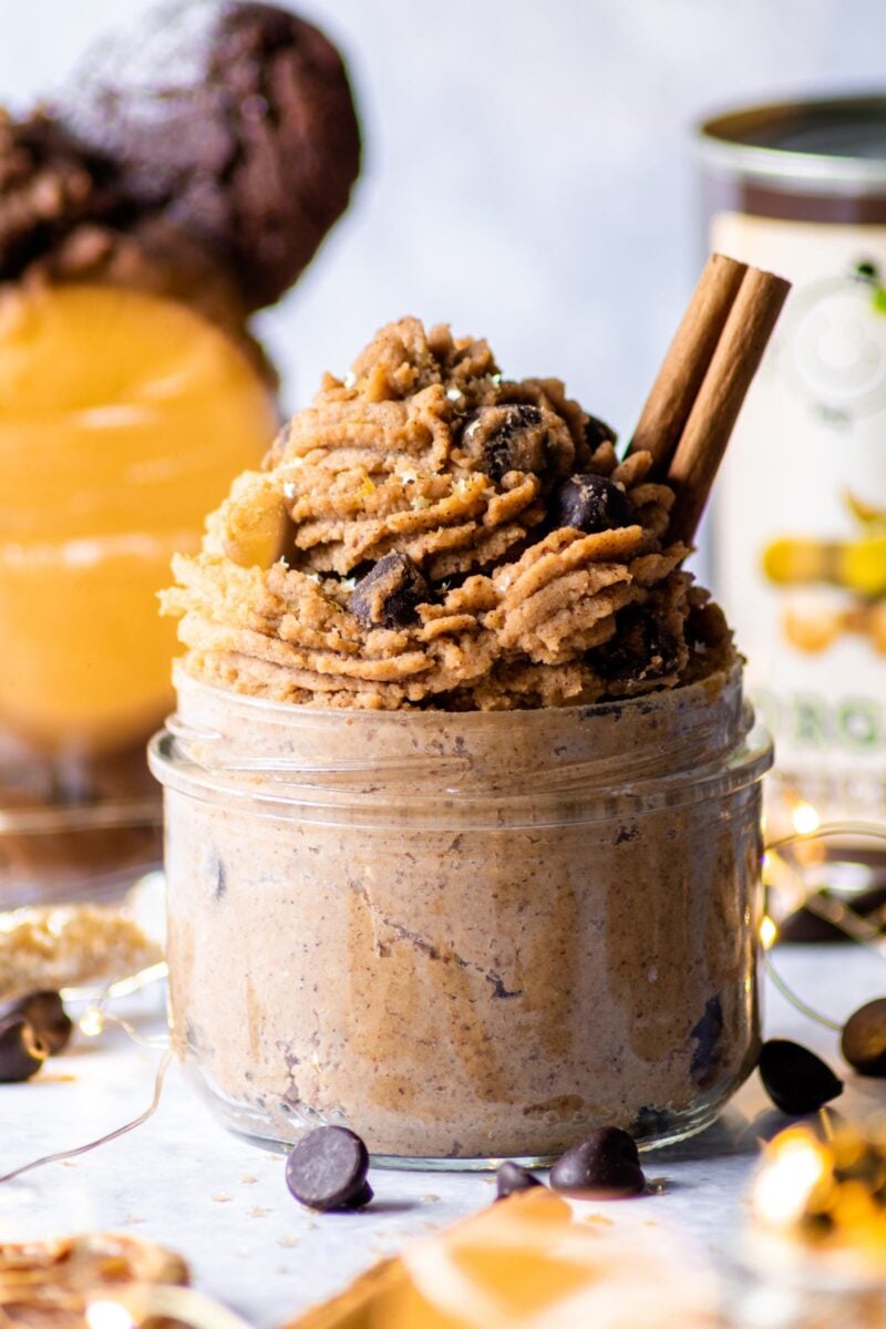 a jar of piped vegan gingerbread cookie dough made with chickpeas and almond butter