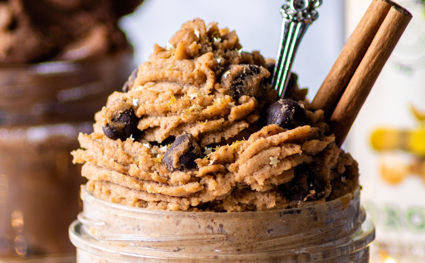 a jar of piped vegan gingerbread cookie dough made with chickpeas and almond butter