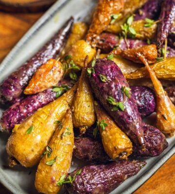 a plate of glazed rainbow carrots roasted in agave, olive oil, herbs, and apple cider vinegar