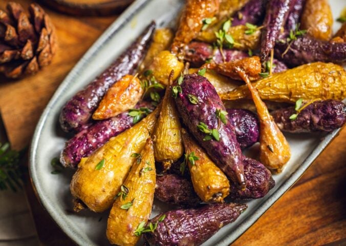 a plate of glazed rainbow carrots roasted in agave, olive oil, herbs, and apple cider vinegar