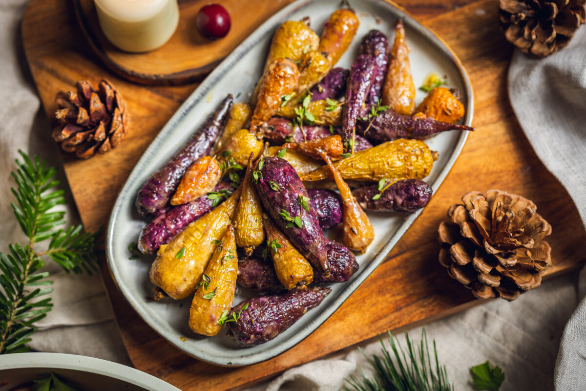 a plate of glazed rainbow carrots roasted in agave, olive oil, herbs, and apple cider vinegar