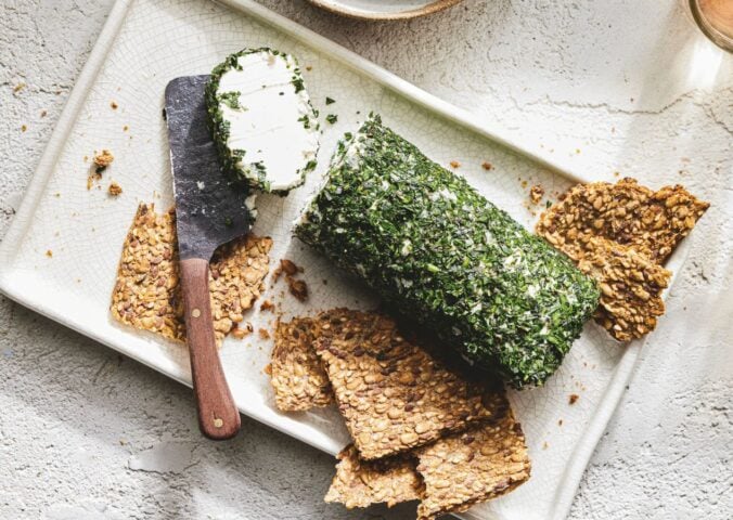 a picture of a log of vegan goat-style cheese rolled in herbs