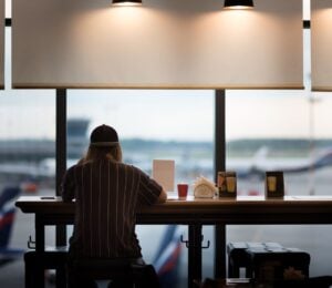 A person eating food at an airport