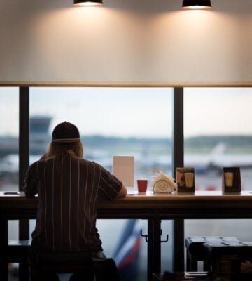 A person eating food at an airport