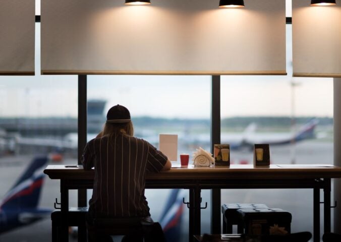 A person eating food at an airport