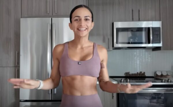 Vegan athlete Natalie Matthews standing in her kitchen