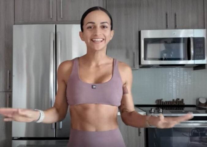 Vegan athlete Natalie Matthews standing in her kitchen