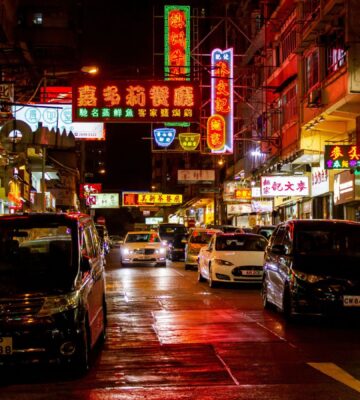 A brightly-lit Hong Kong street at night